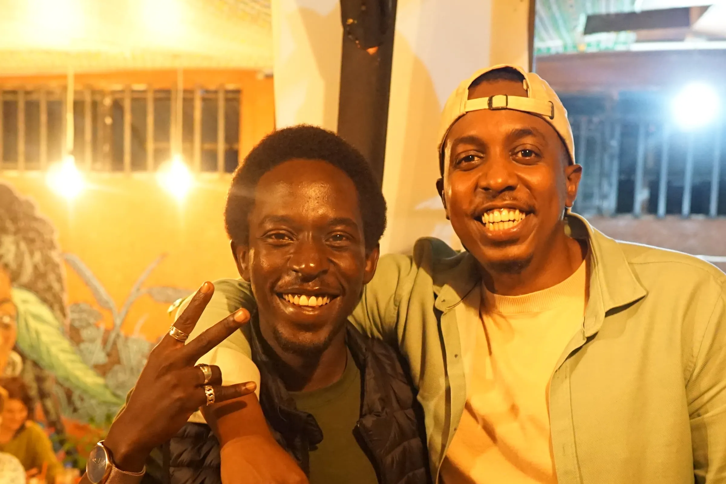 Two friends grinning at the camera during game night