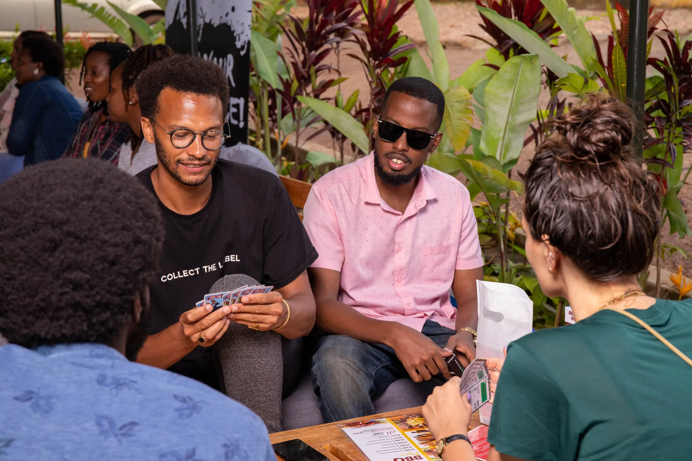 Friends gathered around a table in a leafy garden café