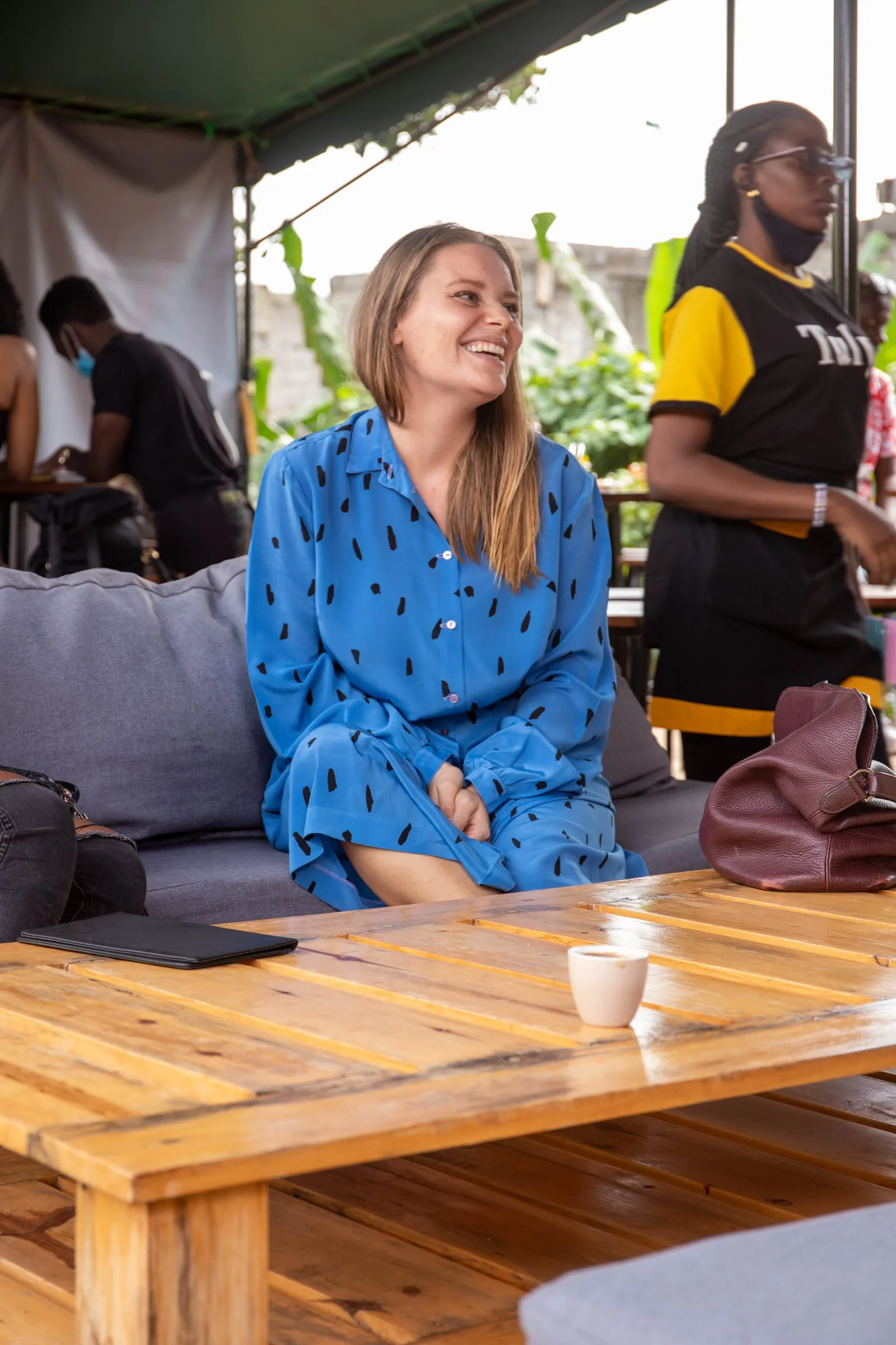 A guest smiling on a lounge sofa
